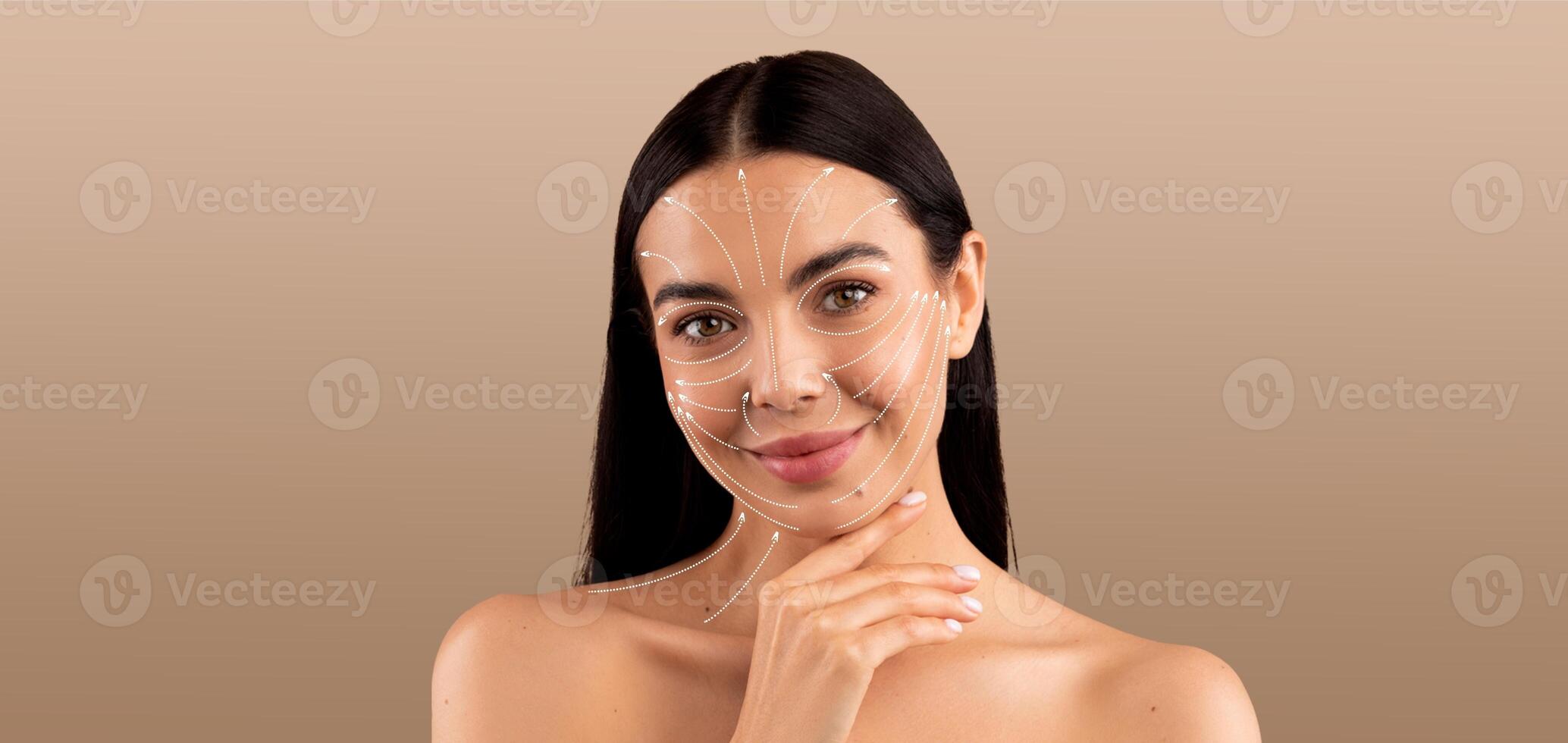 A woman is engaging in her skin care routine, pampering herself with a relaxed expression. She is in a minimalistic environment that highlights her beauty and tranquility. photo