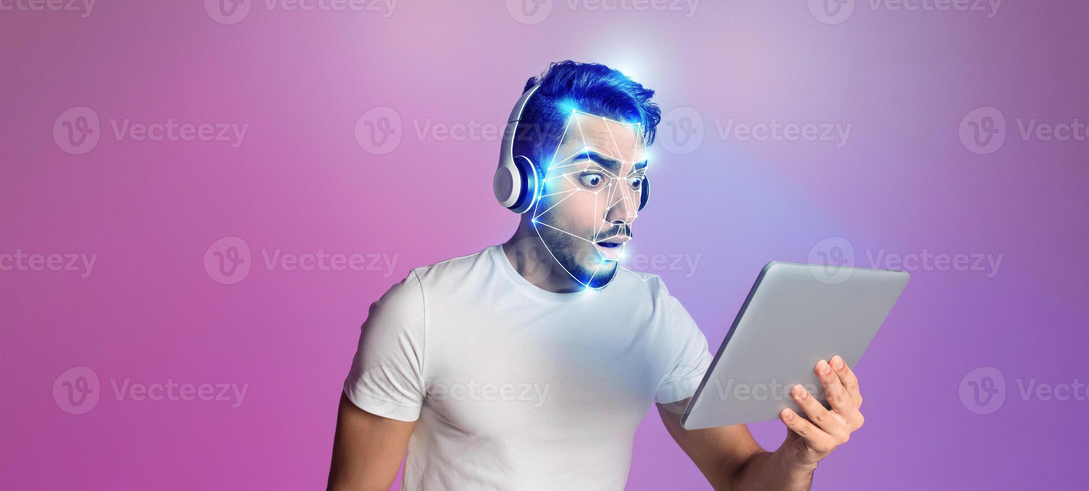 A person with headphones looks surprised while using a tablet. Their facial features are enhanced with a glowing digital overlay, symbolizing modern identification technology in action. photo