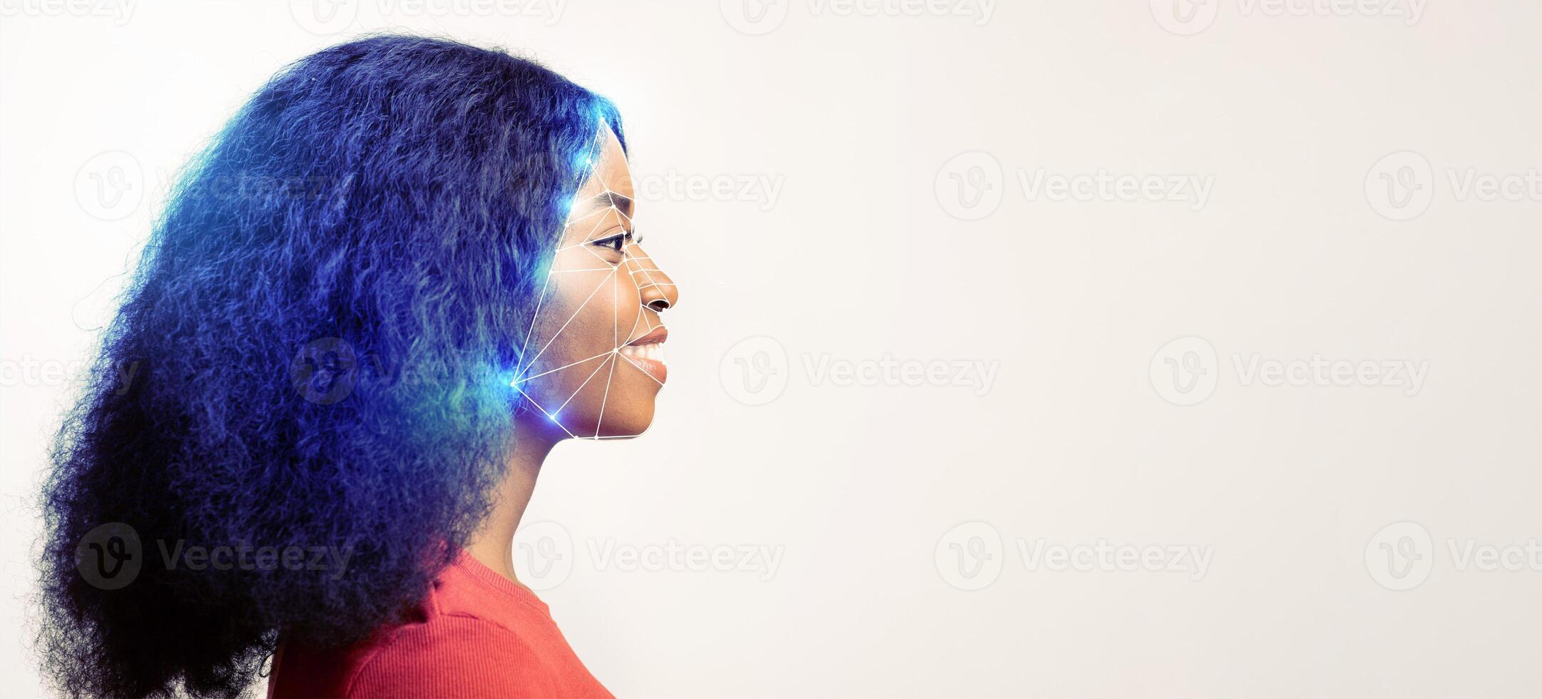 A woman profiles her face towards the right, showcasing human features and modern technology for identification. Blue light indicates facial mapping in a minimalistic space. photo