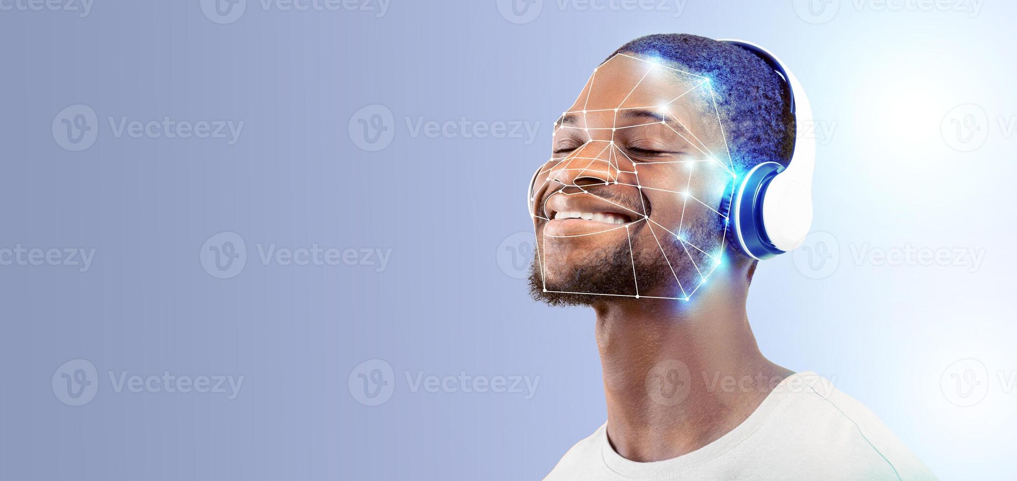 A smiling individual with headphones engages with modern facial recognition technology. photo