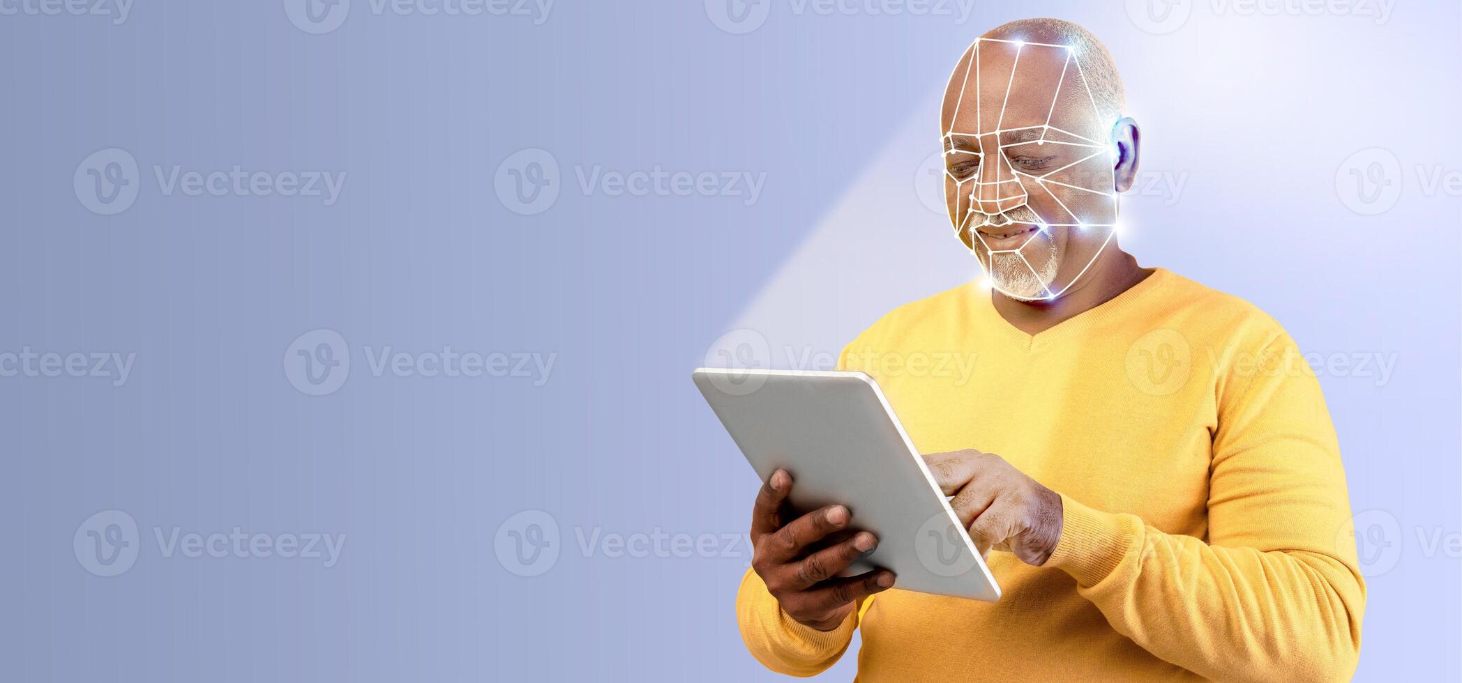 A man with a thoughtful expression interacts with a tablet, utilizing facial recognition technology. The setting features a clean, isolated background with ample copy space, emphasizing the activity. photo