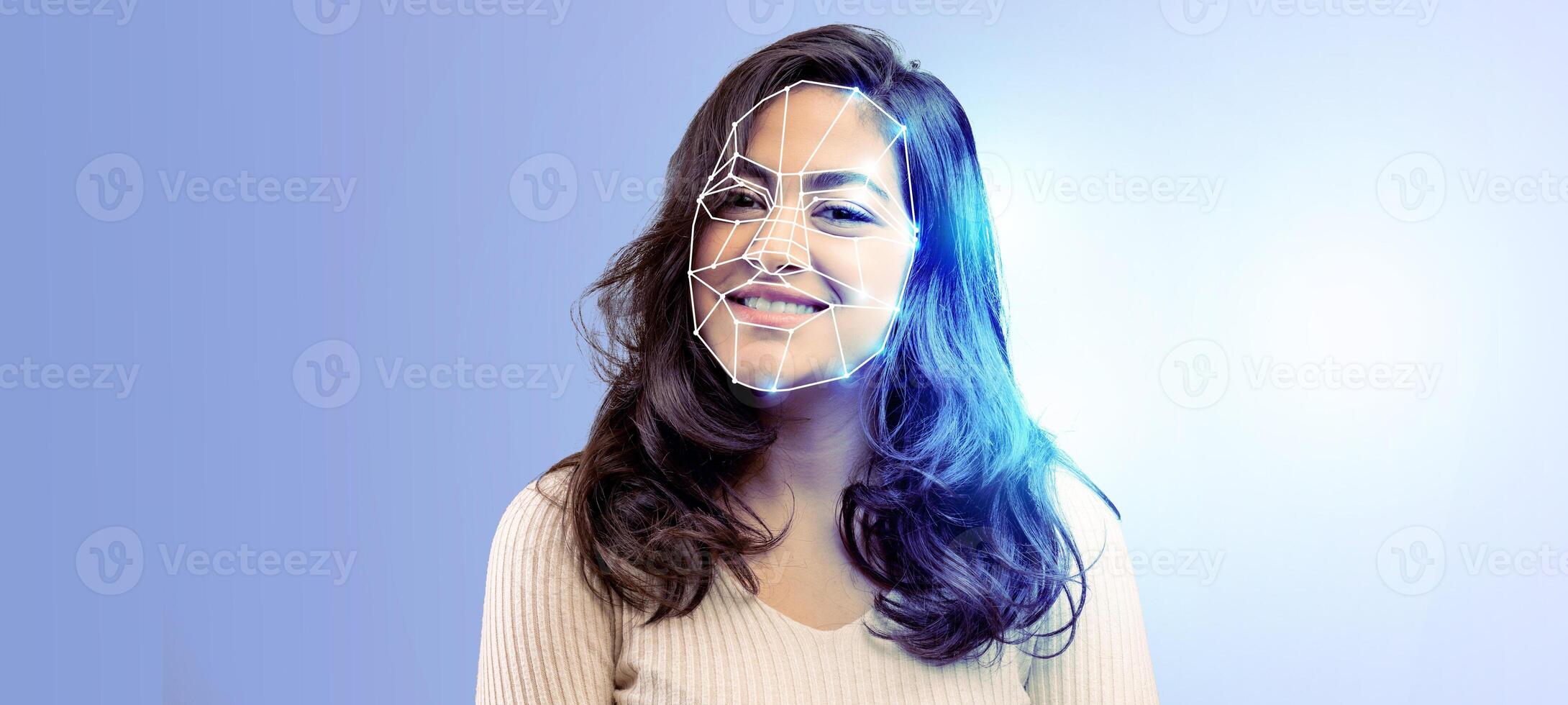 A smiling individual is highlighted with digital facial recognition technology. The modern, isolated backdrop emphasizes data analysis and identification concepts. photo