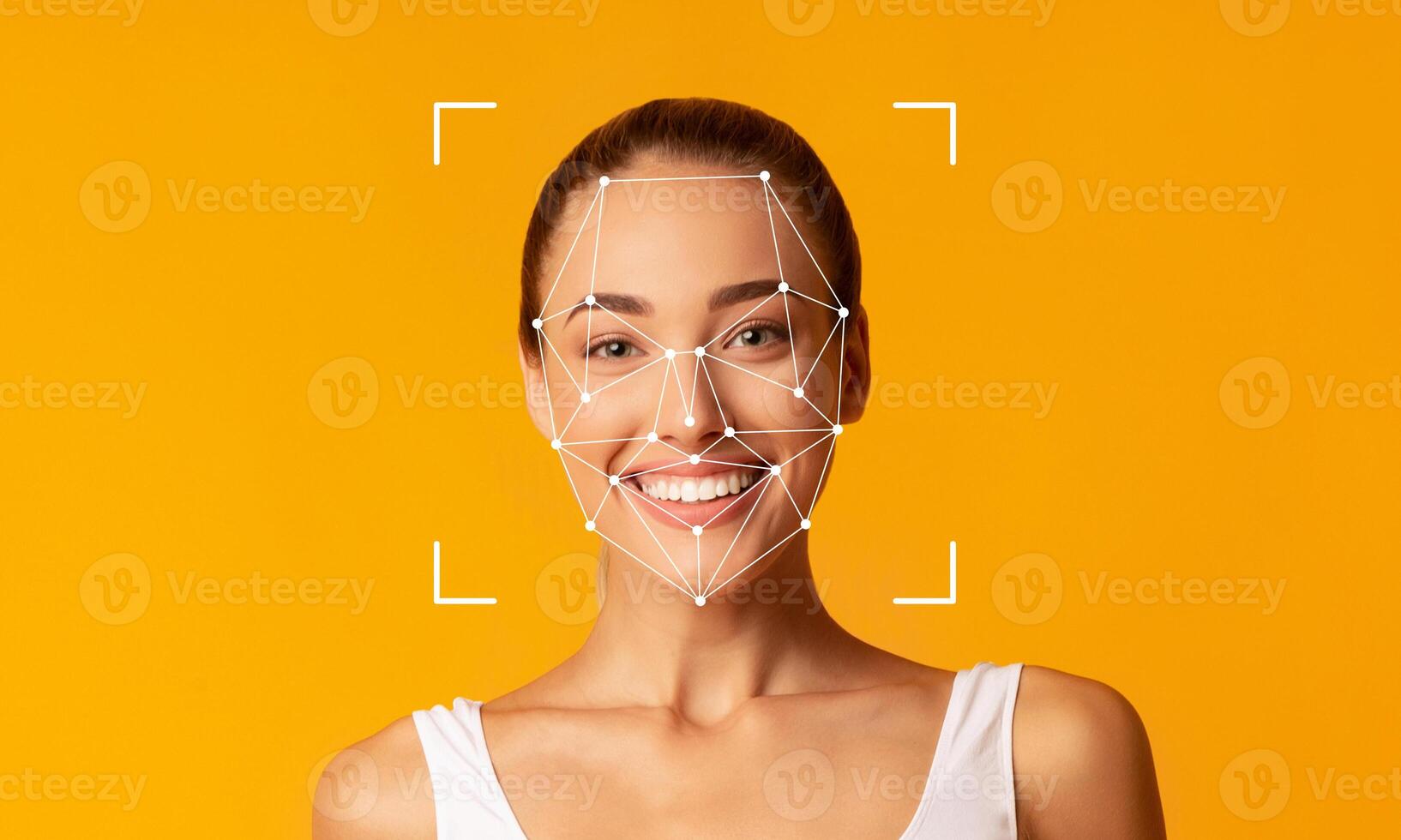 A smiling woman stands in front of a bright yellow background, demonstrating facial recognition technology. The facial features are highlighted with geometric patterns, indicating ID capabilities. photo