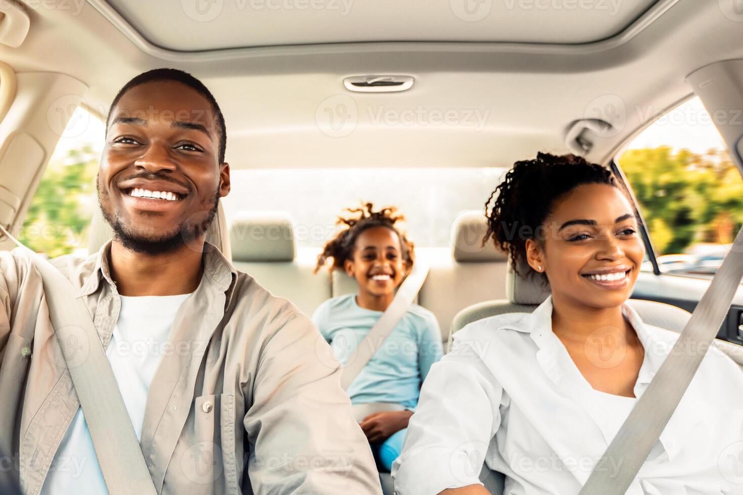 Happy African American Family Riding Car Traveling By Automobile. Black Parents And Daughter Enjoying Summer Road Trip Together On Weekend. Panorama, Selective Focus photo
