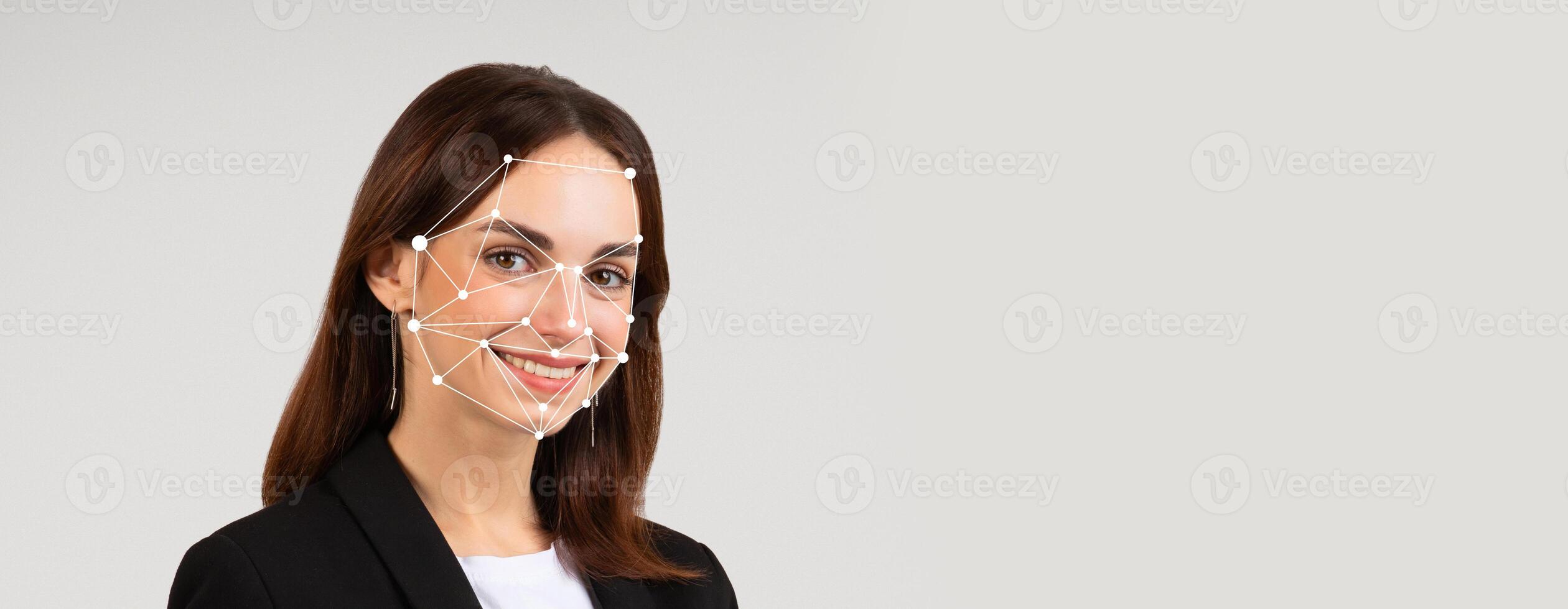 A person smiles while facial recognition technology analyzes their features. This innovative method aids in identification and verification in various applications. photo