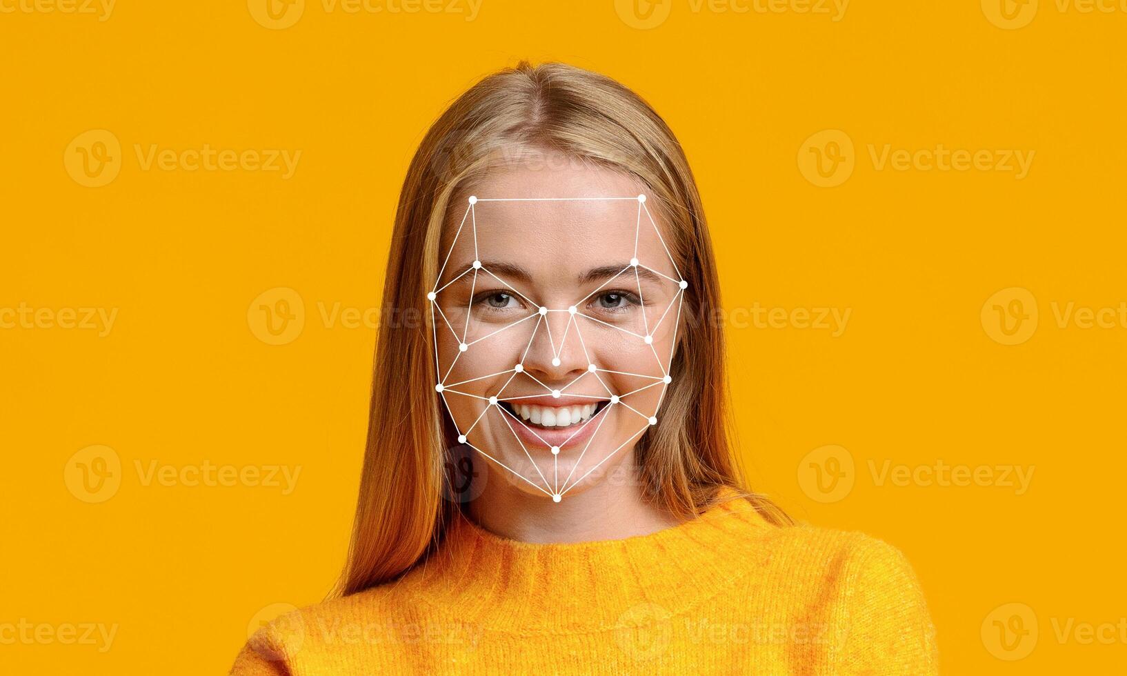 A young woman in a bright orange sweater smiles while facing the camera. Over her face, a digital overlay illustrates facial recognition features, showcasing modern technology. photo