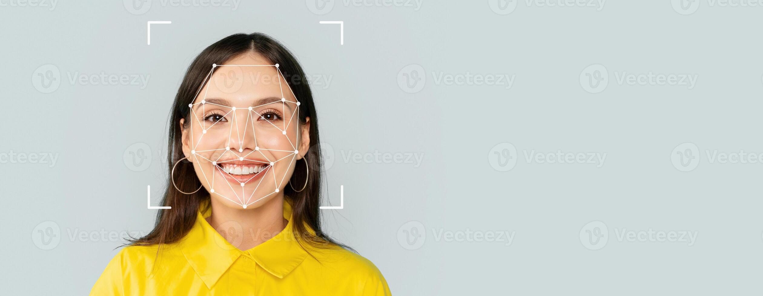 A smiling individual with a neutral background is being analyzed by facial recognition technology, showcasing the application of identification methods in modern settings. photo