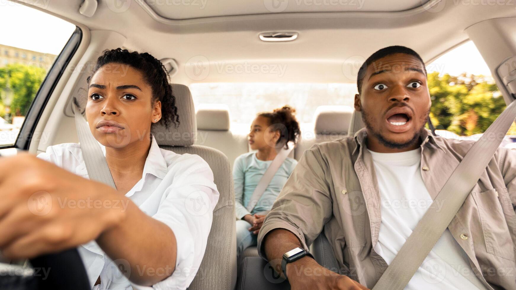 Danger Of Car Accident. Black Family Riding Auto Having Risk Of Crash While Wife Driving Automobile And Shocked Husband Looking At The Road. Dangerous Trip Concept photo