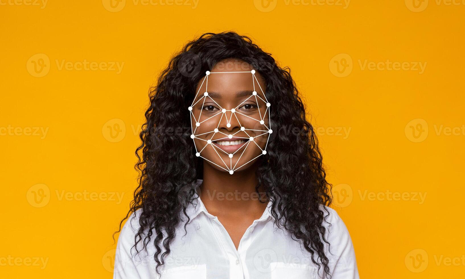 A young woman smiles directly at the camera as advanced facial recognition technology highlights her facial features against a bright yellow backdrop. The scene emphasizes identification. photo