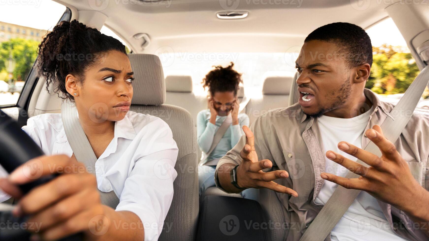 Family Having Quarrel In Car. Mad Husband Shouting At Wife While Woman Driving Auto Having Problem In Relationship. Marital Crisis, Conflict Between Spouses Concept. Selective Focus photo