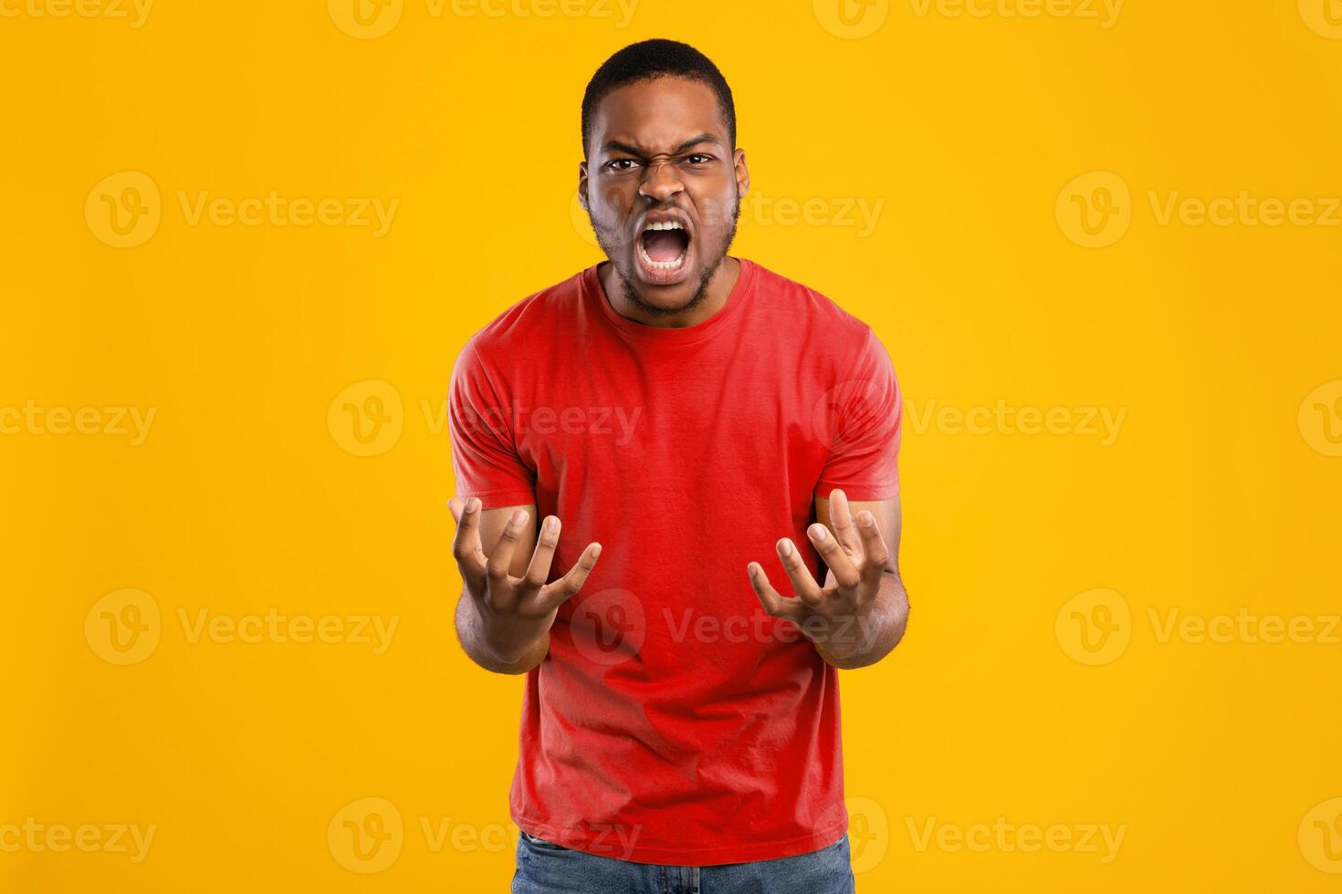 Fury. Angry African American Man Shouting Emotionally Looking At Camera Expressing Anger And Aggression Posing Over Yellow Background In Studio. Negative Emotions Concept photo