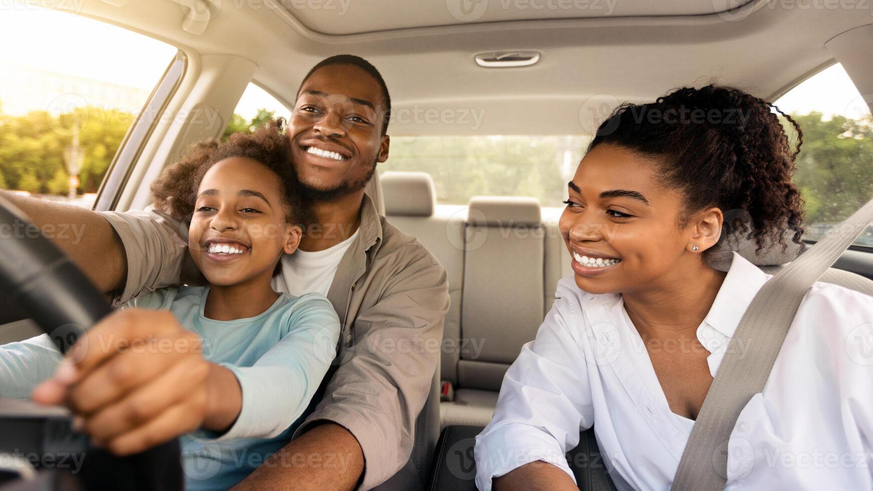 African American Father Teaching His Daughter To Drive Driving The Car Together. Happy Family Riding New Automobile In City, Having Fun Traveling By Auto. Vehicle Transportation photo
