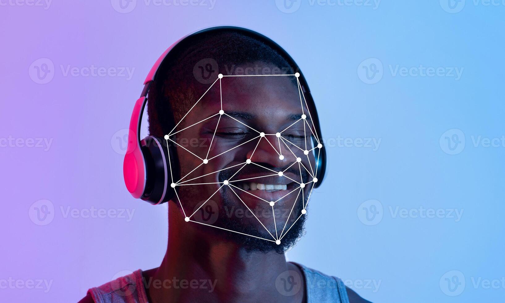 A person enjoys music through headphones while facial recognition technology maps facial features for identification. The vibrant background adds a modern touch to the experience. photo