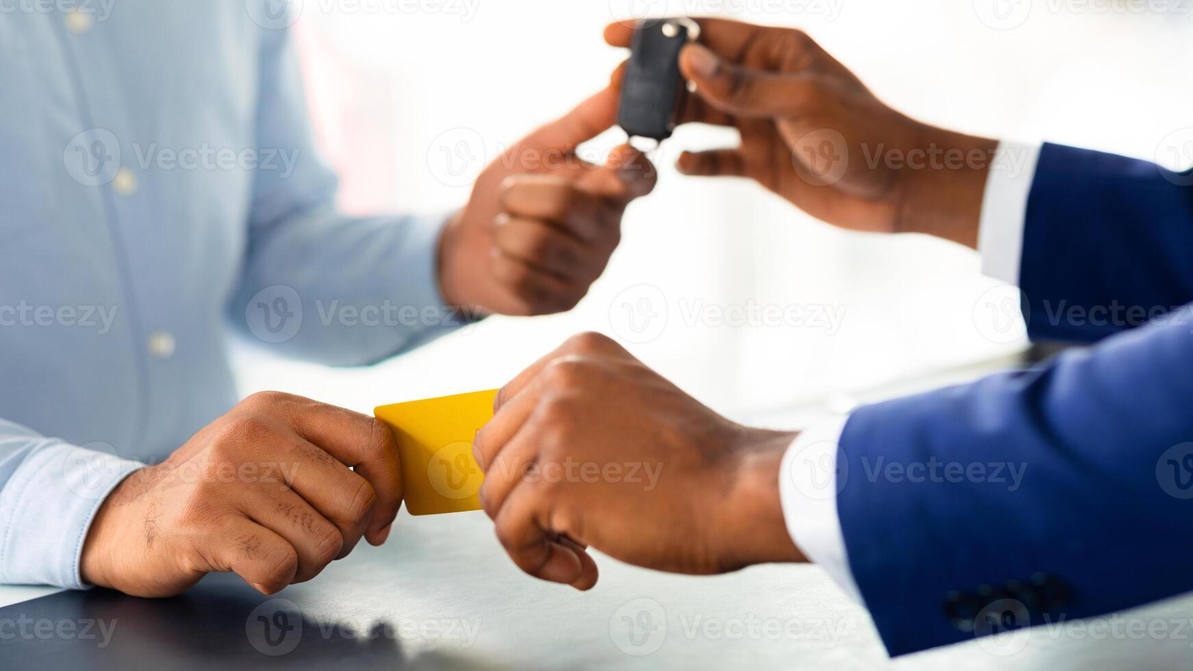 Male Customer Giving Credit Card To Salesperson And Taking Car Keys, Unrecognizable African American Man Renting Or Buying Vehicle In Modern Dealership Office, Cropped Image, Closeup Shot photo