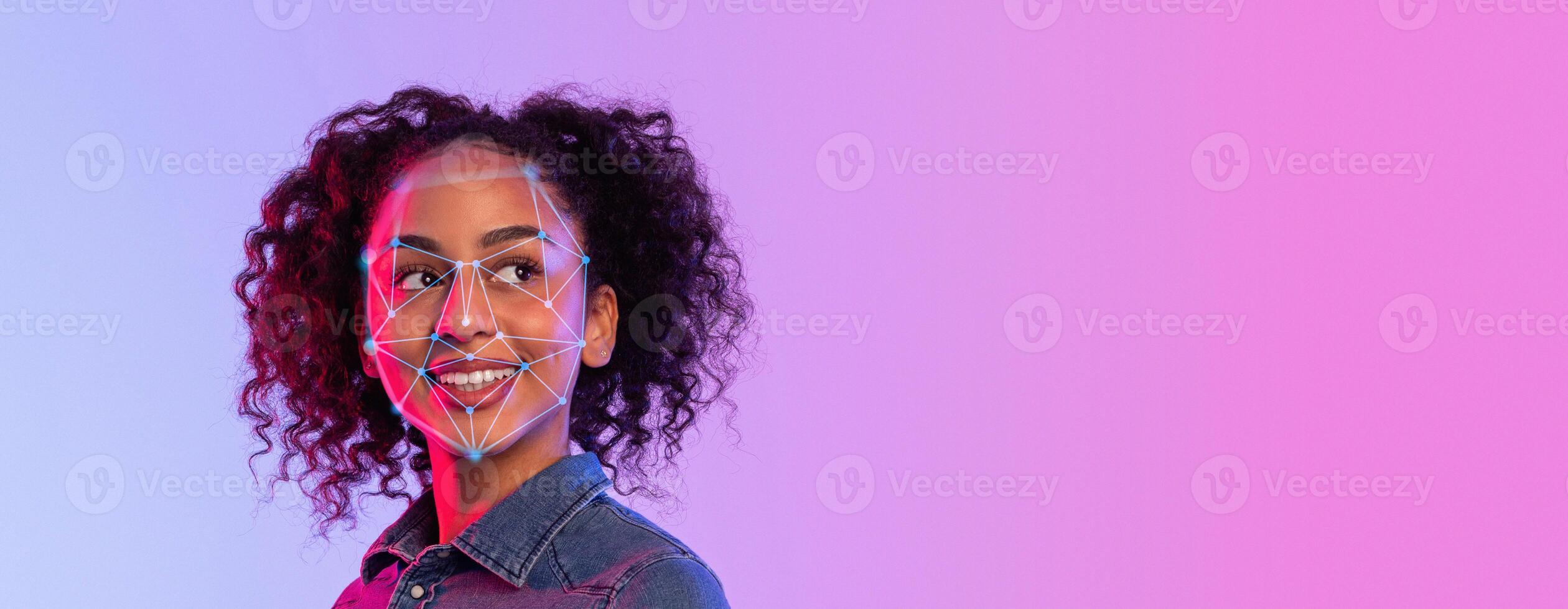 A person with curly hair faces the camera while facial recognition technology highlights specific facial features. The background consists of a vibrant gradient, creating a modern atmosphere. photo