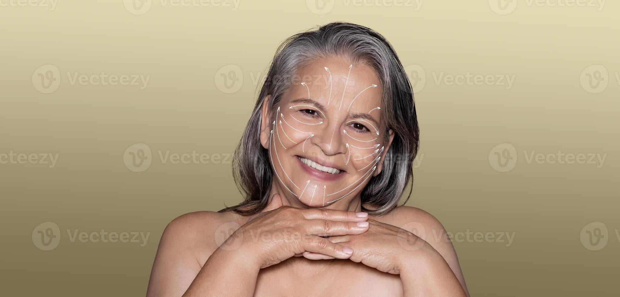 A woman experiences a tranquil skin care routine, showcasing her beauty and well-being. She smiles contentedly while nurturing her skin in a serene, minimalist setting with empty space. photo