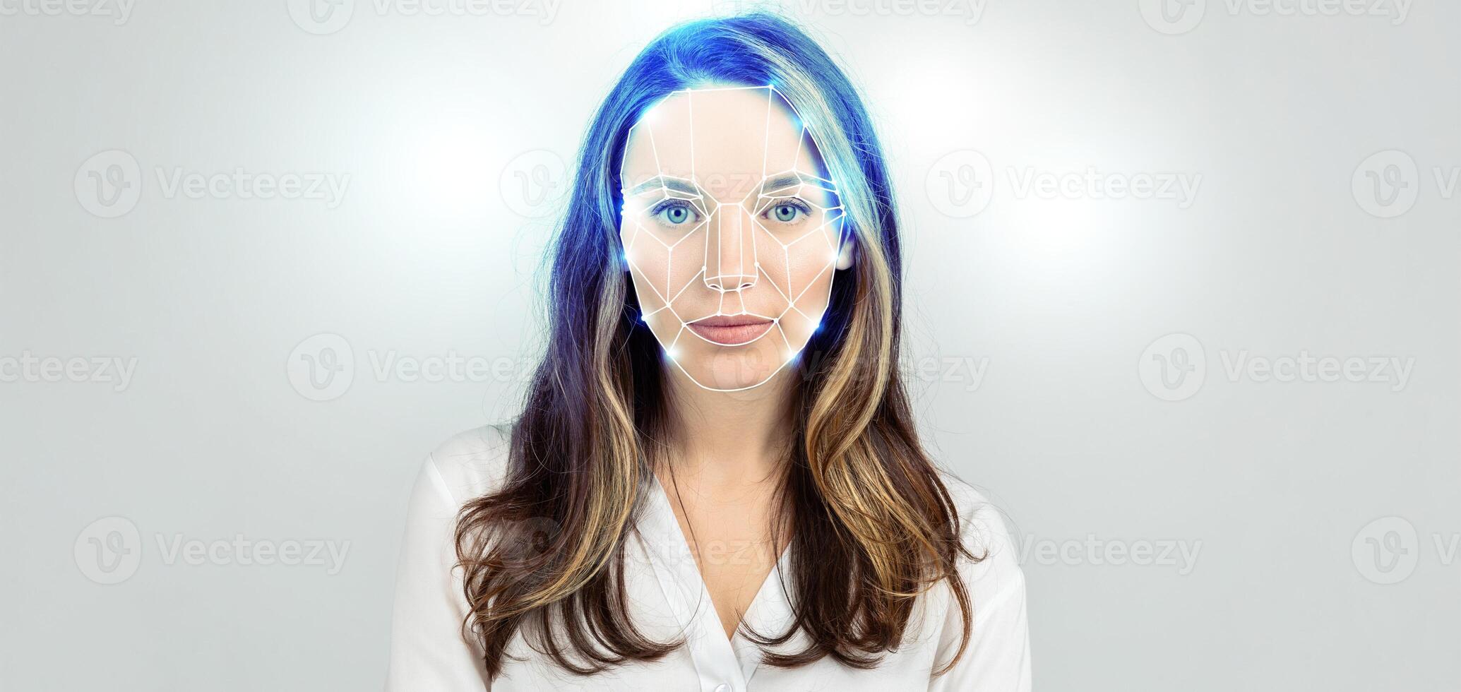 A woman stands with a neutral expression, as advanced facial recognition technology scans her features. The backdrop is a plain white space, emphasizing the futuristic aspect of identification. photo
