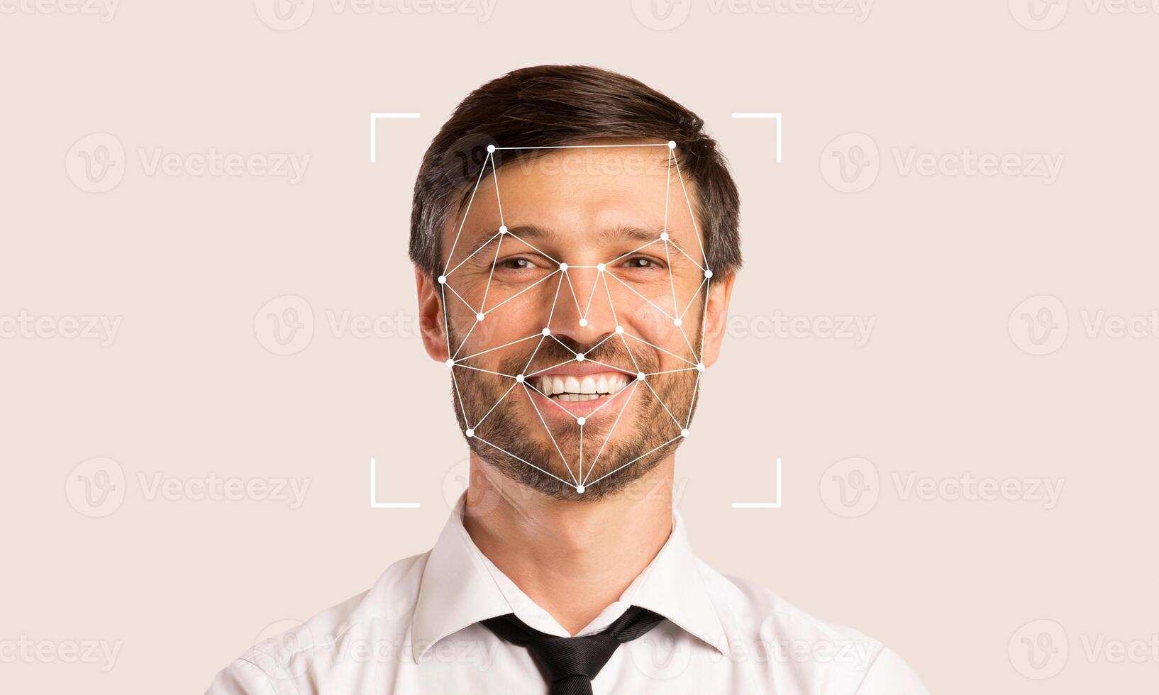 A smiling man is shown with facial recognition markers overlaid. This technology is used for identification and verification. The background provides empty space enhancing focus on the subject. photo
