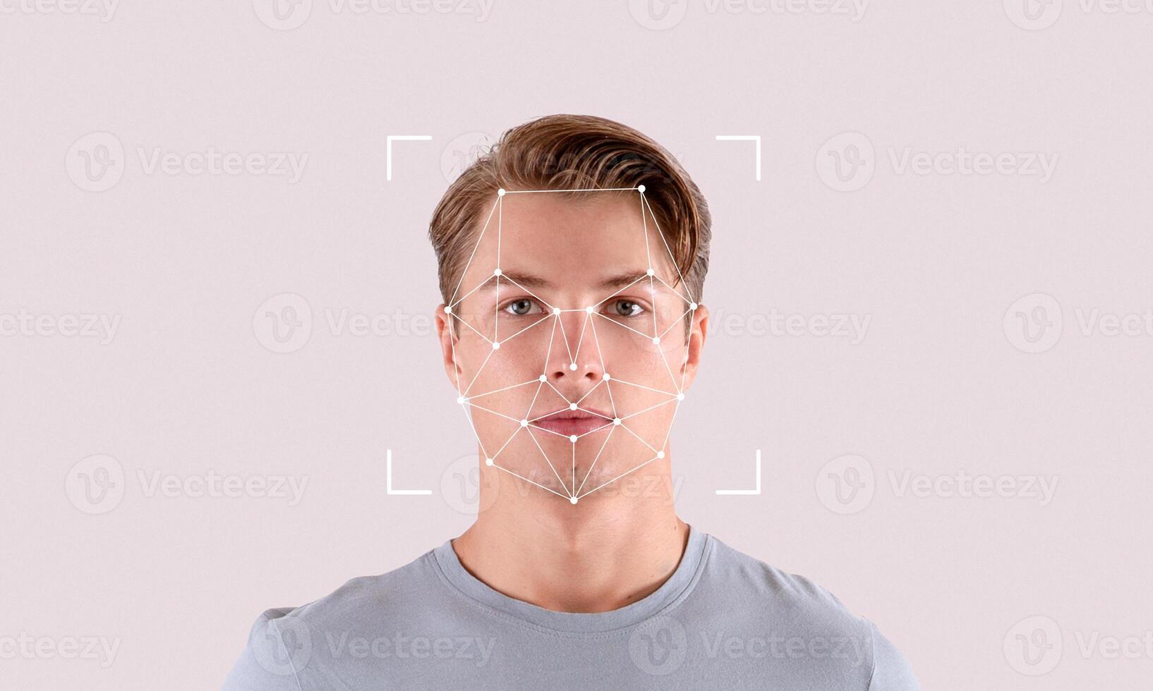 A young man stands against a plain backdrop while facial recognition technology highlights his features. This illustration shows the process of digital identification accurately. photo