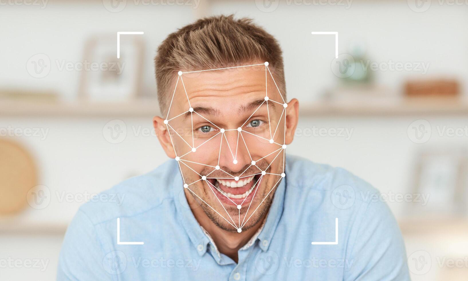 A man with a cheerful expression is interacting with facial recognition technology at his home. The background features a modern decor, enhancing the atmosphere of innovation and engagement. photo