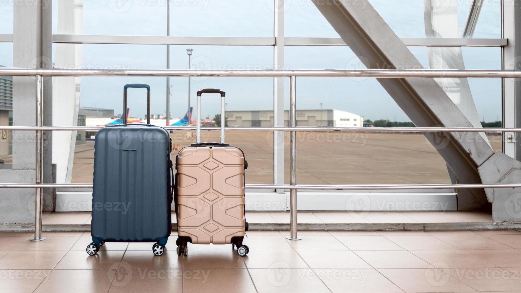 Shot Of Two Stylish Suitcases Standing Near Window At Empty Airport, Hand Luggage Or Cabin Baggage Size Bags Waiting In Terminal, Advertisement Banner For Air Travels And Flight Bookings, Copy Space photo