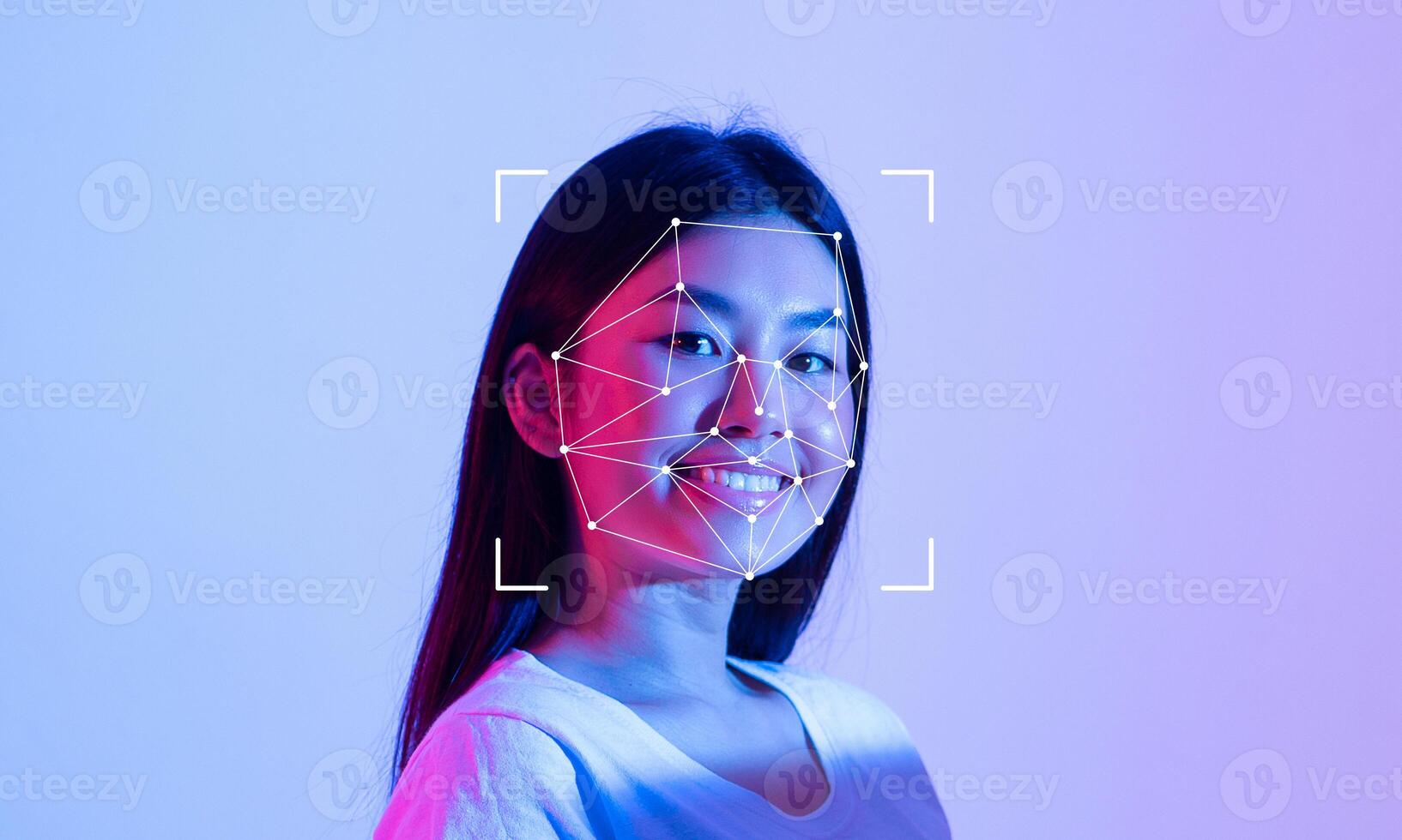 A young person is smiling while facial recognition technology is illustrated on their face. photo