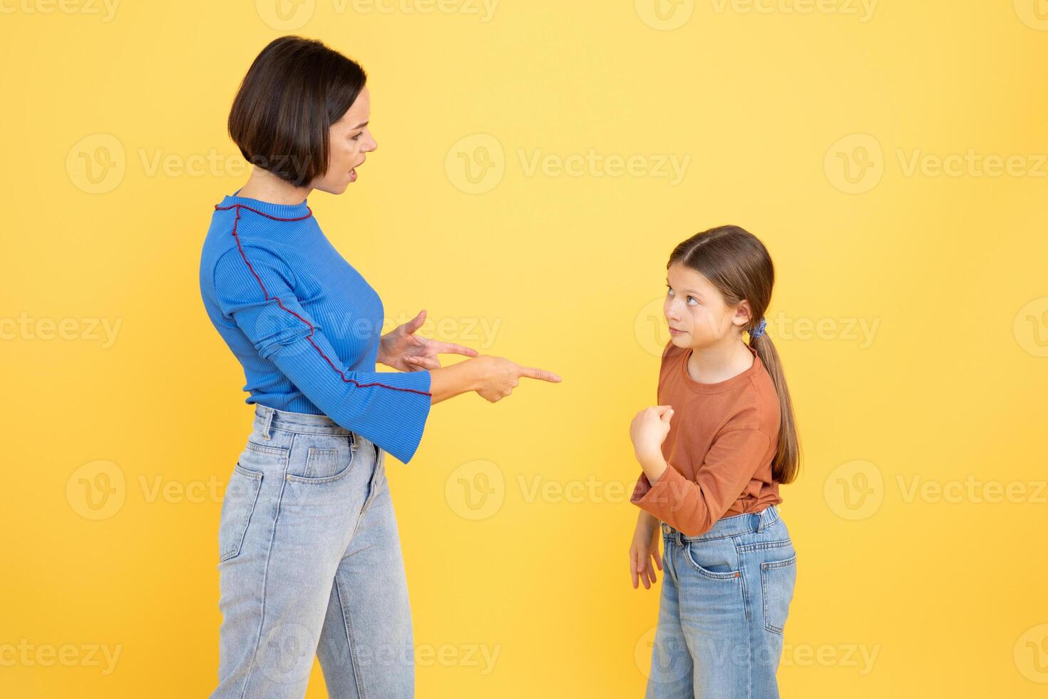 A mother engages her preteen daughter in a supportive manner, pointing while the girl listens attentively. photo