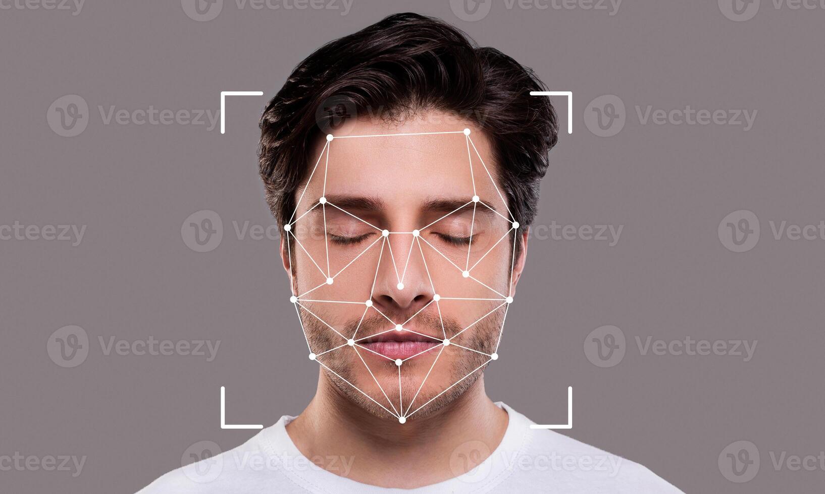 A person with closed eyes is engaged in facial recognition technology. An overlay of geometric shapes indicates the mapping of facial features for identification purposes. photo