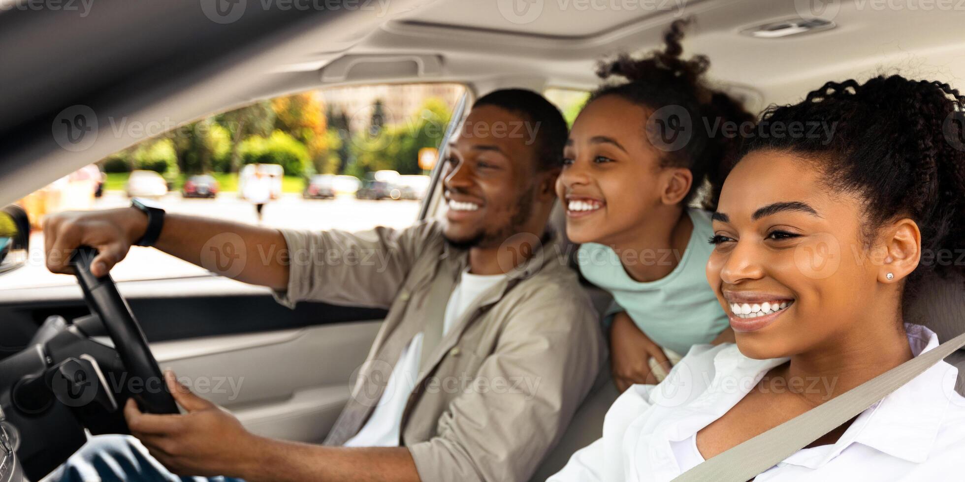 Side View Of Cheerful Family Driving A Car Having Road Trip. Parents And Daughter Sitting In Automobile Seats Smiling Looking Aside. Auto Leasing And Purchase. Selective Focus photo