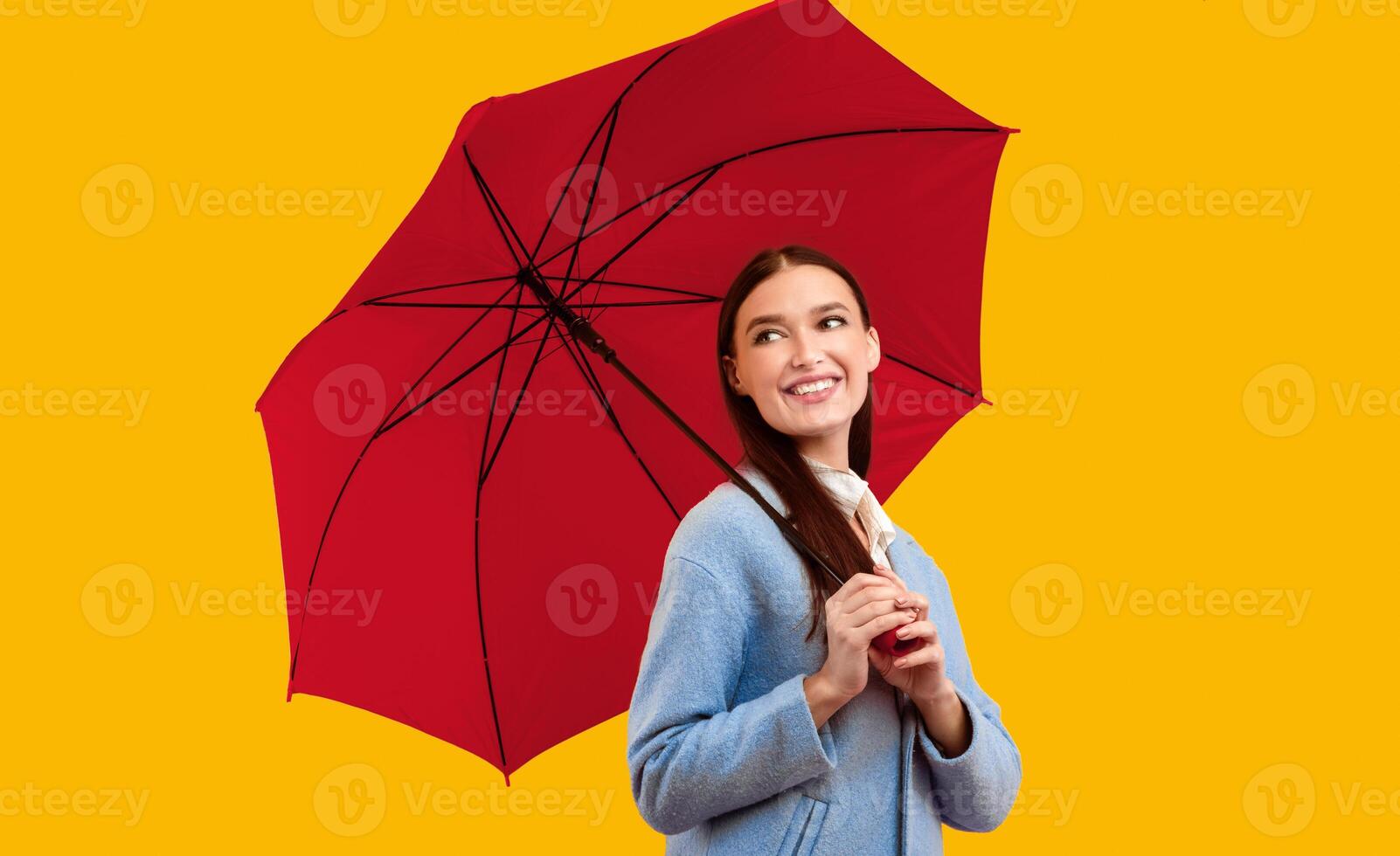 Stylish Accessories. Portrait of smiling lady standing with yellow umbrella and looking aside photo