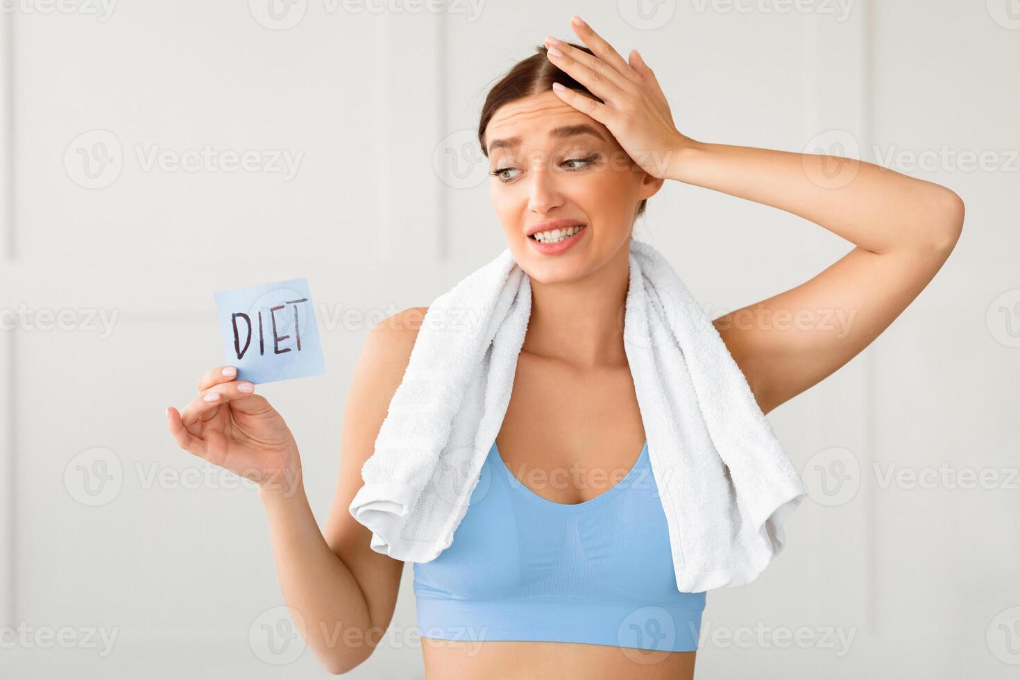 Dieting. Confused Woman Holding Card With Word Diet Choosing Nutrition For Weight Loss Slimming At Home photo
