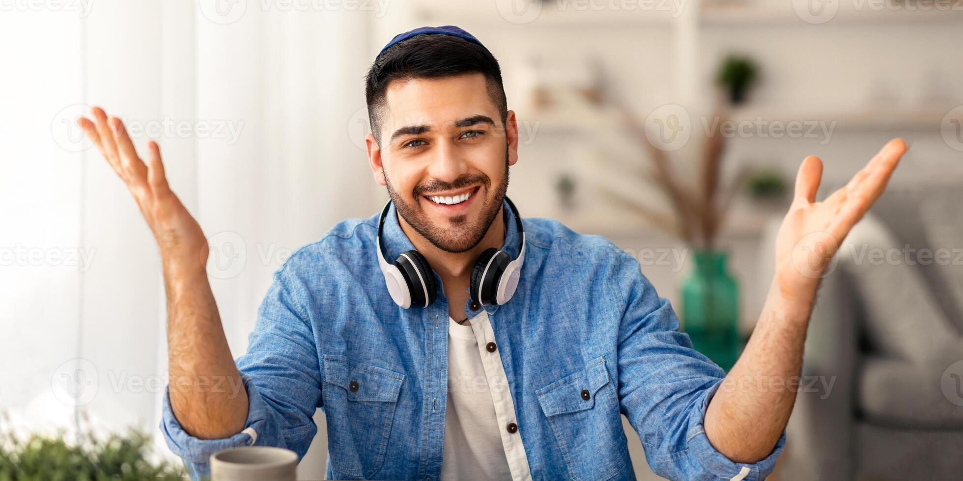 Portrait of smiling israeli man looking at camera, gesturing and talking with clients online. Web camera view of young guy chatting with people remotely via call, banner, panorama photo