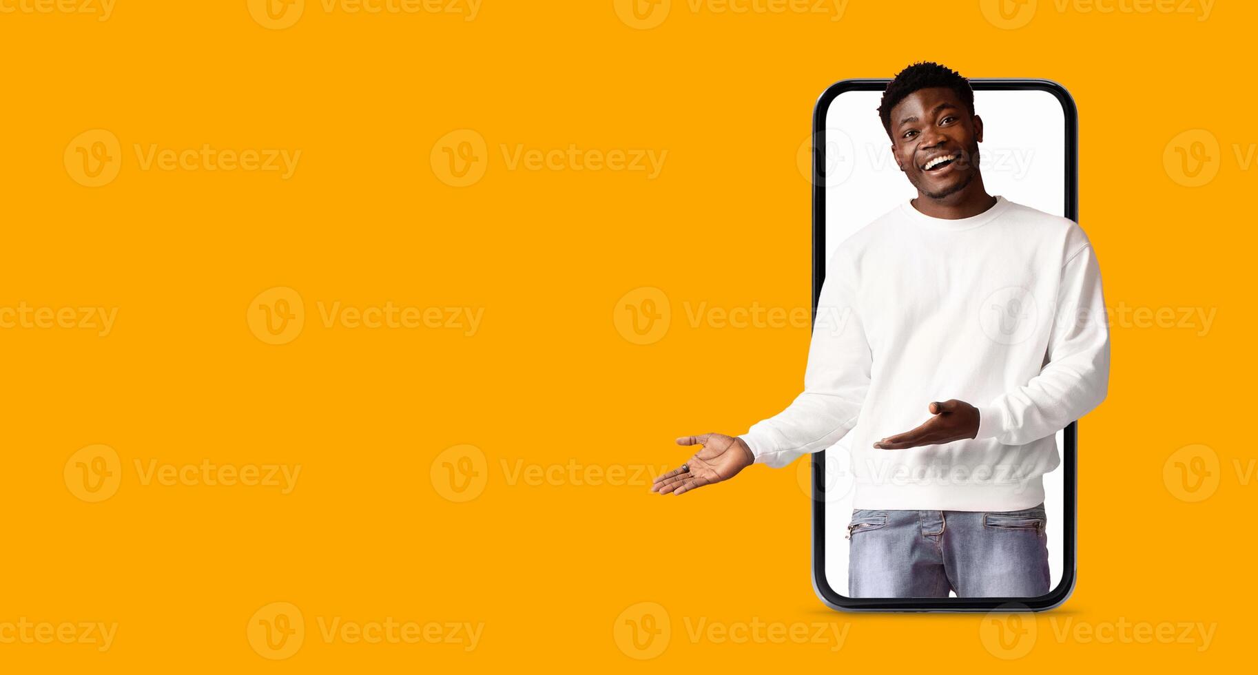 A person is engaged in communication using a smartphone with a large screen. Bright orange background emphasizes the interaction, highlighting modern technology and social media applications. photo