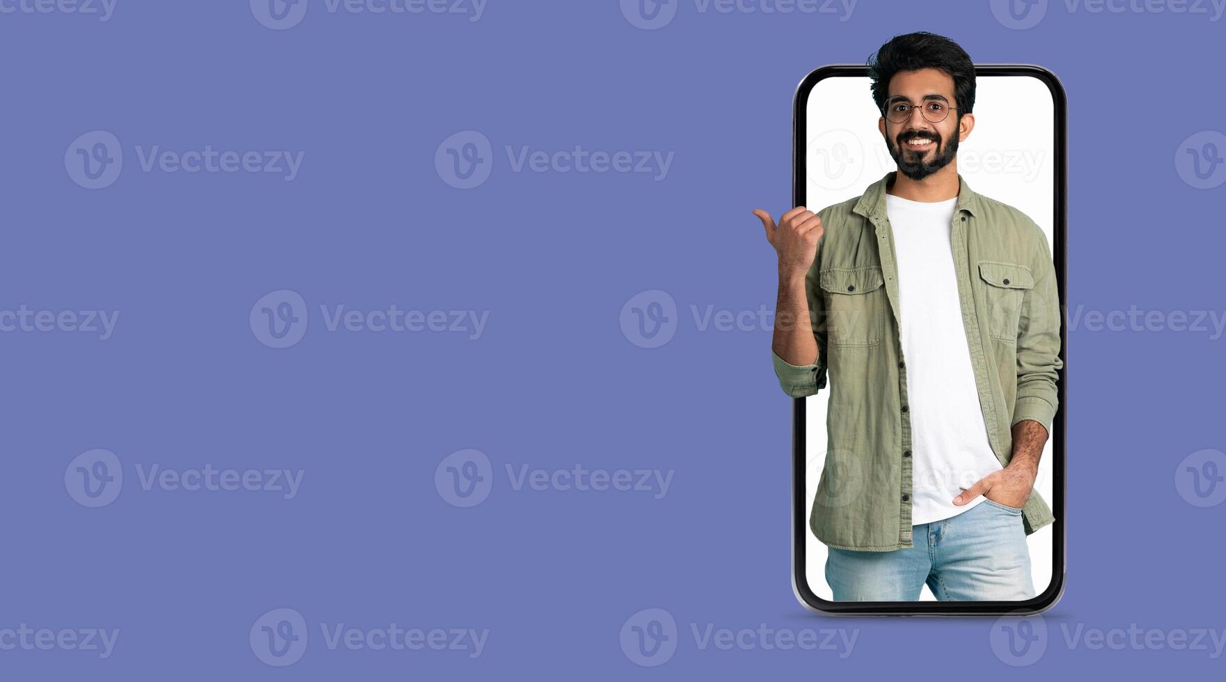 A young man smiles while interacting through a smartphone with a large screen, showcasing the convenience of modern technology for social media and communication. photo