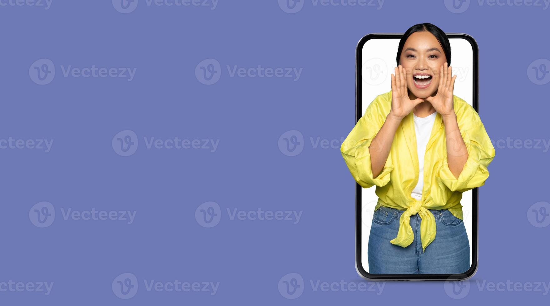 A person enthusiastically interacts with friends via a large smartphone screen, showcasing the importance of social media in modern communication. The individual appears joyful and connected. photo