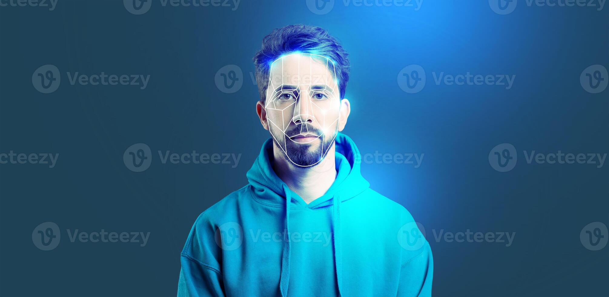 A person stands against a blue background, showcasing facial recognition technology that highlights identification features on their face. photo