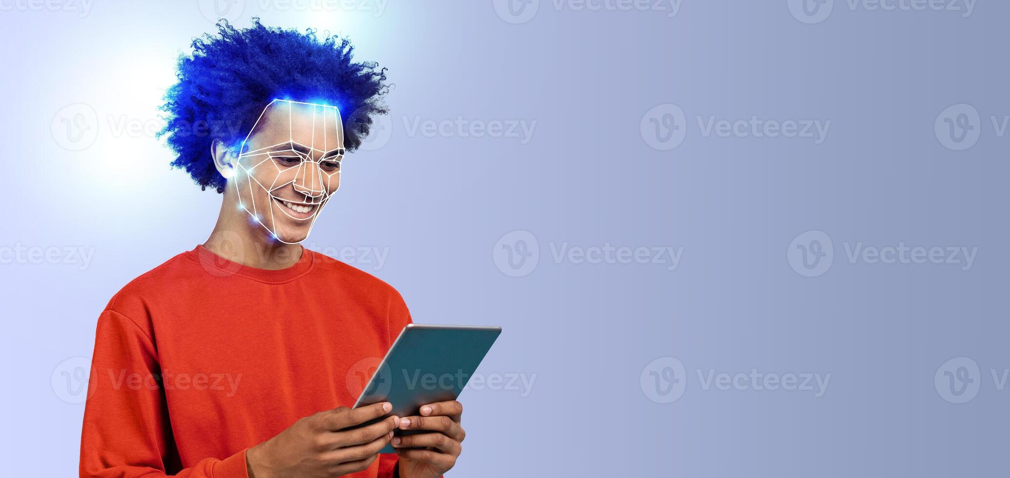 A young person with a cheerful expression engages with a tablet while facial recognition technology is illustrated on their face. The background is a solid, light color, emphasizing the subject. photo
