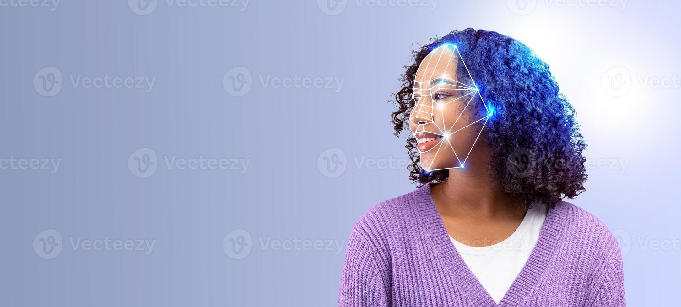 A smiling woman with curly hair is positioned against a solid background, showcasing advanced facial recognition technology. The technology highlights key facial features for identification. photo