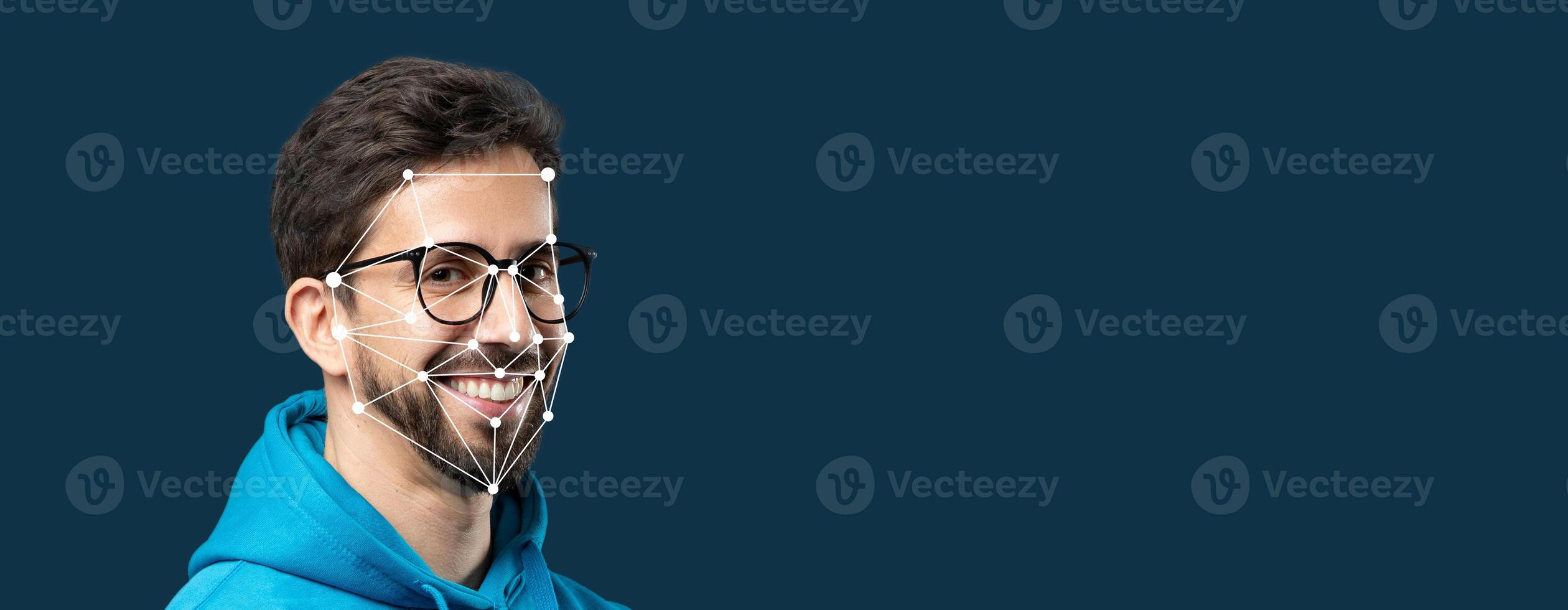 A smiling person with glasses has facial recognition technology overlaying their face. This showcases advanced identification technology in an isolated setting with a blank background. photo