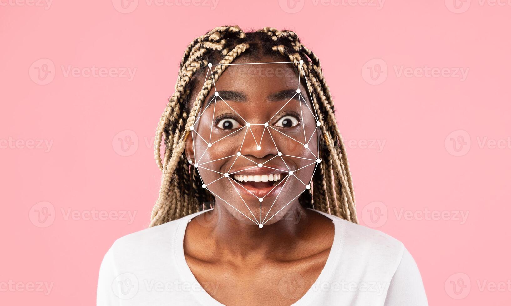 A joyful individual displays a wide smile while facial recognition technology maps their features. The backdrop is a soft pink, creating an engaging and lively atmosphere. photo