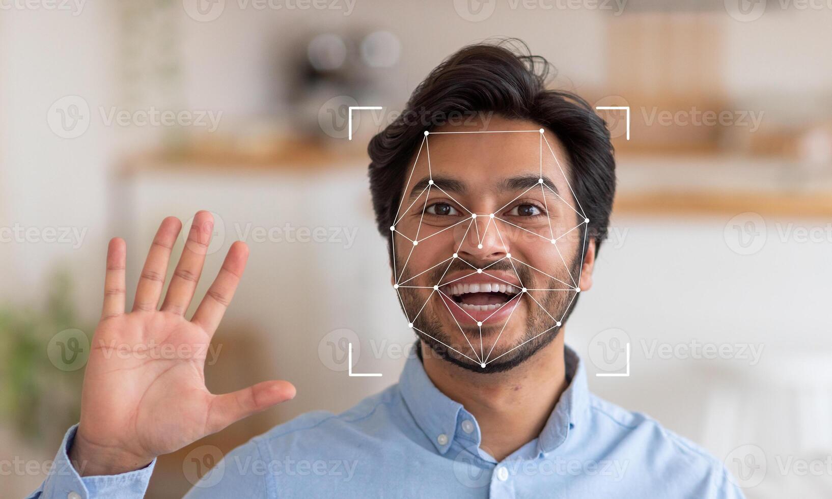 A man is smiling and waving, with facial recognition technology overlaying his face, demonstrating identification capabilities in a contemporary environment filled with light. photo