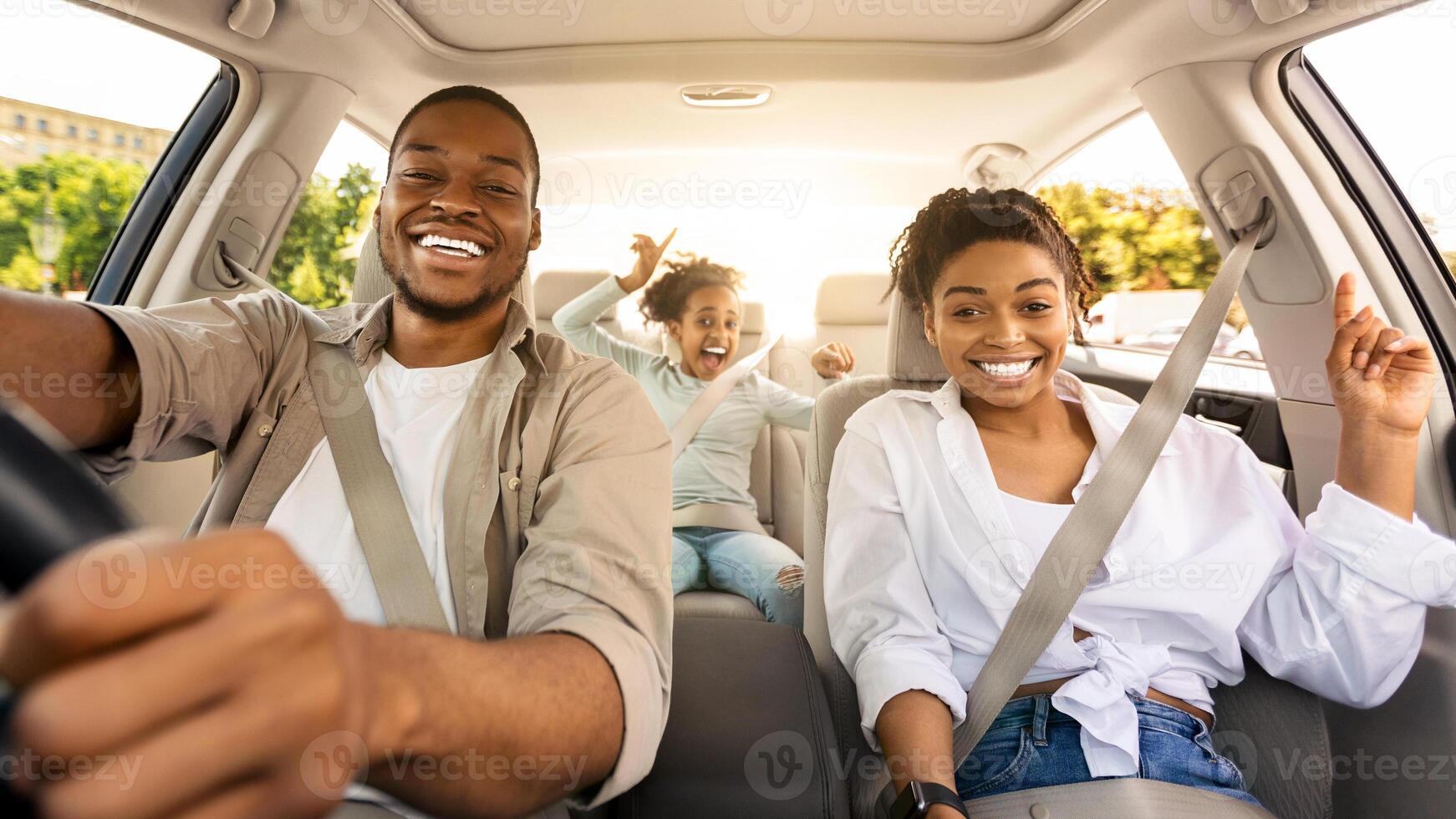 Black Family Riding Car Traveling Together In Summer, Smiling To Camera. Parents And Preteen Daughter Sitting In New Automobile. Auto Ownership And Purchase Concept. Selective Focus photo