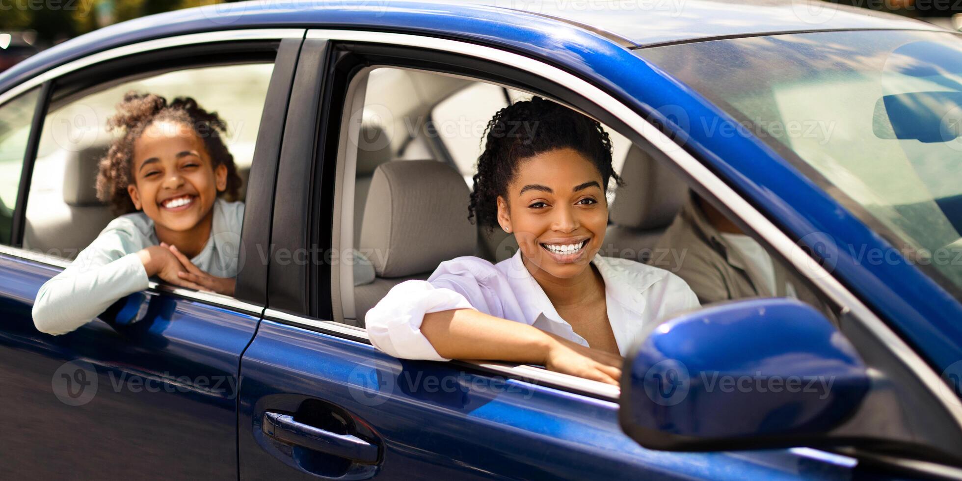African American Family Posing Sitting In Blue Car In Urban Area. Parents And Daughter Driving New Auto Enjoying Ride Smiling To Camera. Automobile Purchase And Rent Concept. Selective Focus photo