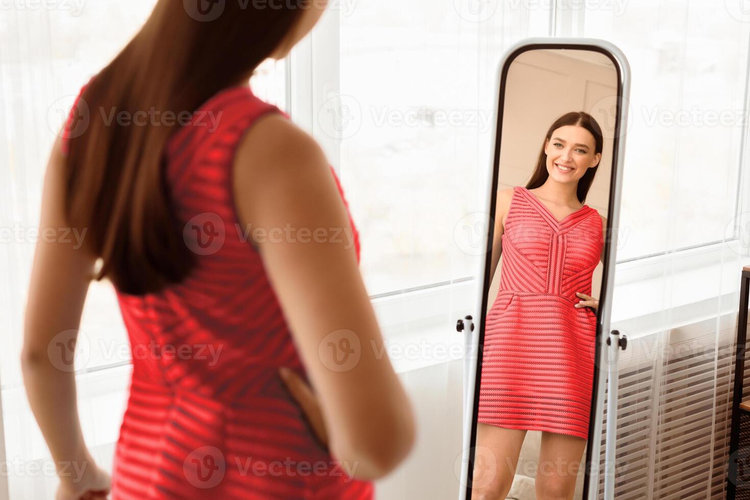 Summer Fashion. Girl In New Dress Looking At Mirror Smiling To Her Reflection Posing Standing At Home. Selective Focus photo