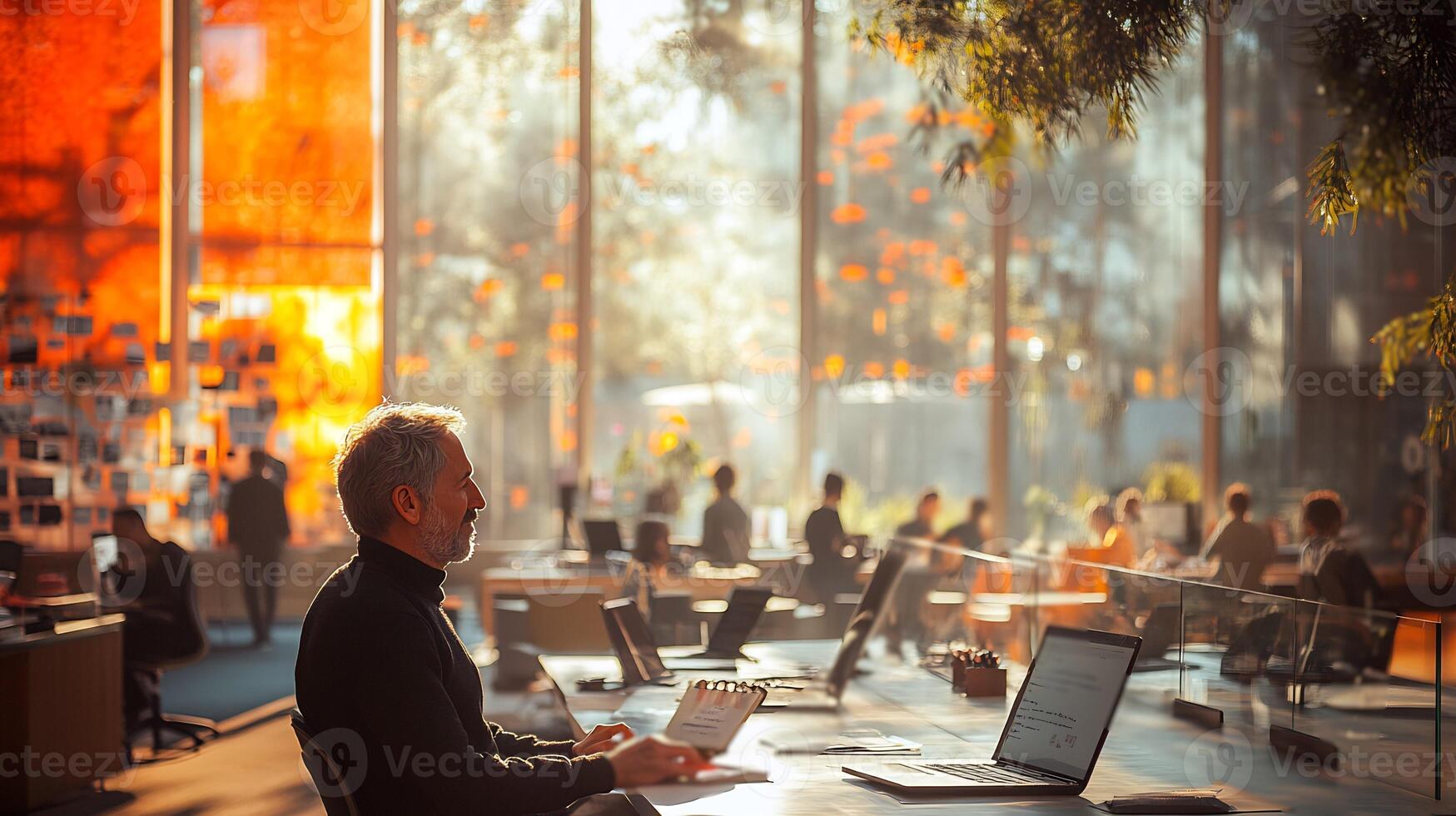 Innovative startup workspace natural light collaborative teams using laptops brainstorming on glass walls and a vibrant techdriven atmosphere photo