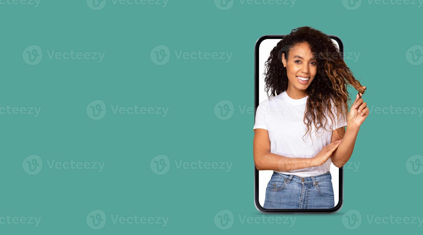 A joyful individual interacts with a smartphone featuring a large screen, showcasing online communication. The background is vibrant, offering ample space for text or graphics. photo