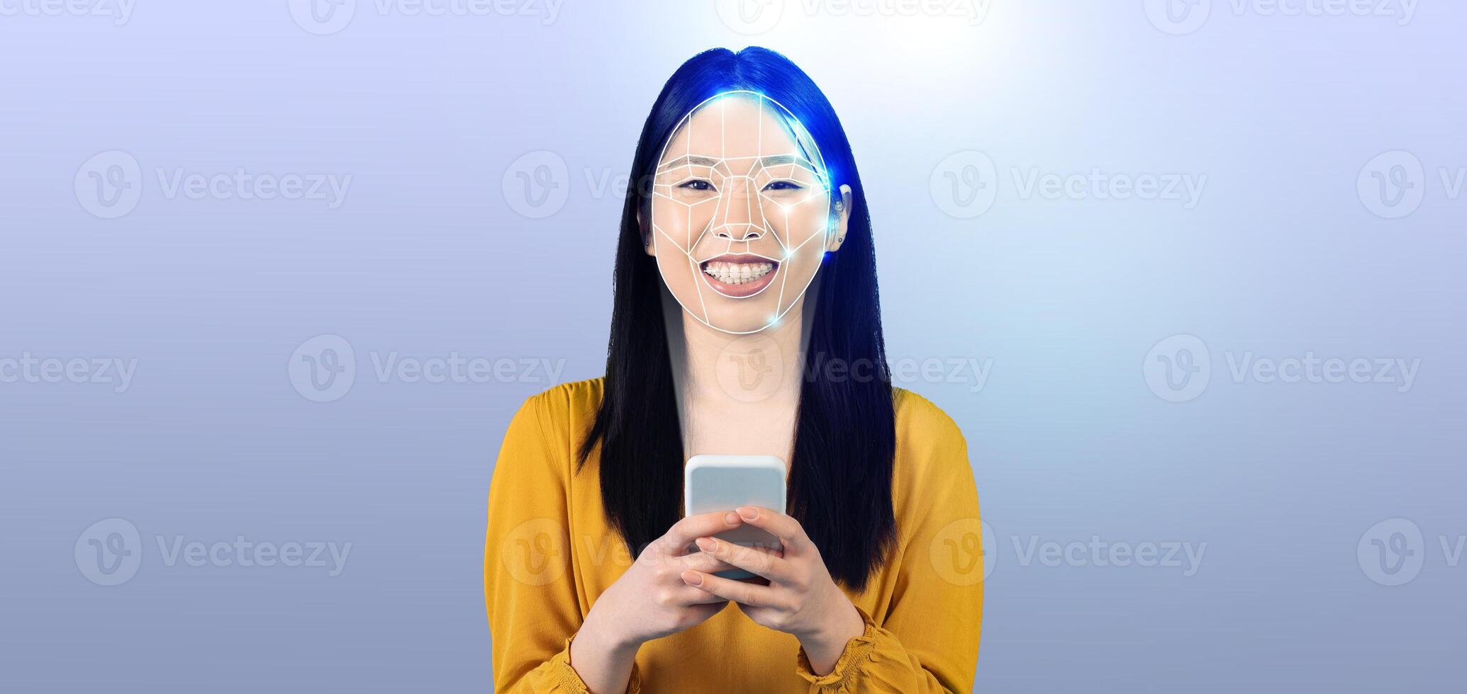 A woman smiles while using her smartphone with facial recognition technology. The background is a clean, empty space, highlighting the innovative aspects of modern identification methods. photo