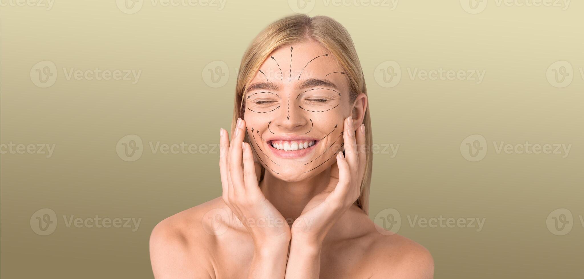 A young woman is smiling with closed eyes while applying skincare products to her face. She is in a calm, isolated environment with a smooth texture in the background, perfect for relaxation. photo