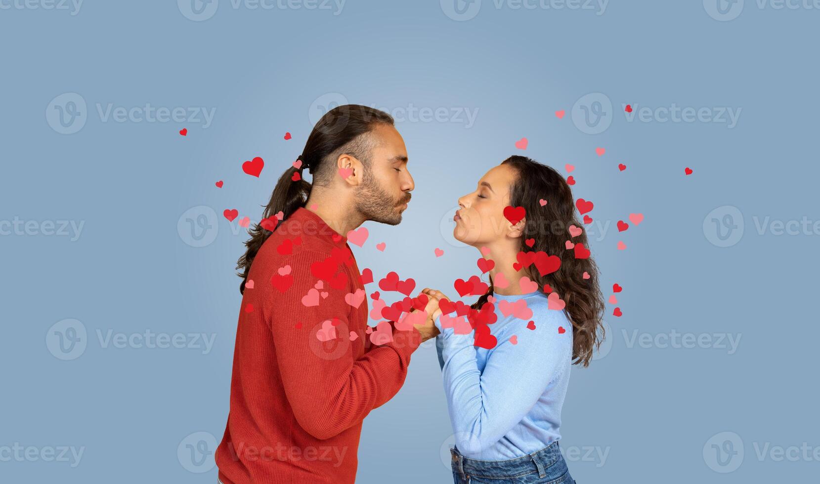A couple expresses their affection through a gentle kiss while surrounded by floating hearts. This moment captures love and connection, perfect for celebrating an anniversary or Valentine's Day. photo