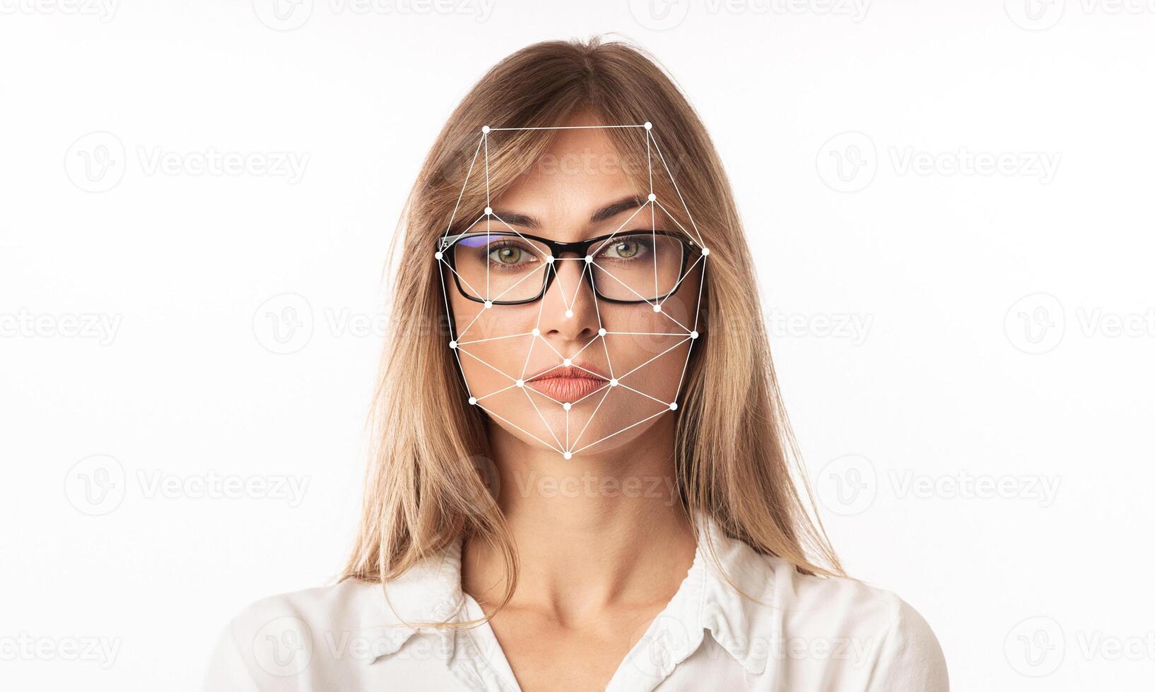 A woman with glasses is featured against a plain background, showcasing a facial recognition overlay highlighting key facial features. This technology emphasizes identification capabilities. photo